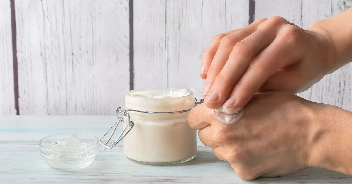 Person applying a homemade after-sun care, with a bowl of fresh aloe vera gel.
